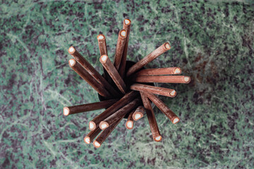 Overhead shot of dark chocolate covered mint sticks on marble top