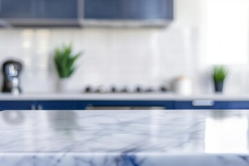 Blurred kitchen scene with marble countertop and blue cabinets