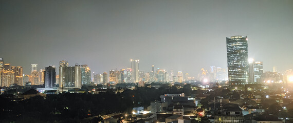 Sensational night view of Jakarta skyline at night. Horizontal banner flat of panoramic...