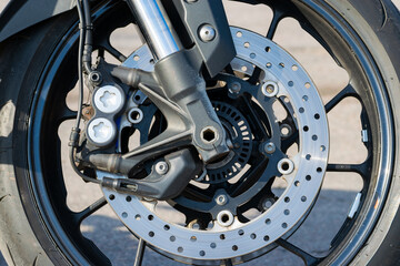 brake disc of a sports motorcycle close-up. Front wheel. The concept of heating during braking. Close-up