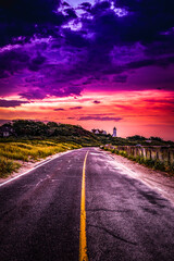 Saturated vibrant ethereal sunset with purple and red cloudscape over the coastal road on Cape Cod, Massachusetts, USA