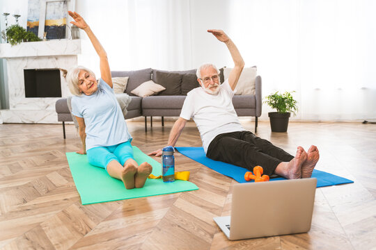 Elderly couple doing fitness at home