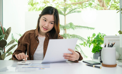 Attractive young entrepreneur working with laptop computer at home.