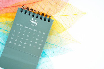 Obraz premium July 2024 monthly desk calendar and fiber structure of dry leaves texture, skeleton leaf.