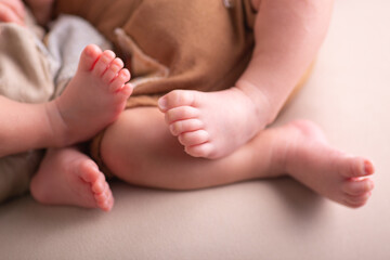 Twins together Newborn little human baby feet and hands