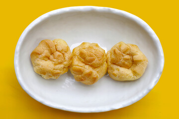 Cream puffs in white bowl