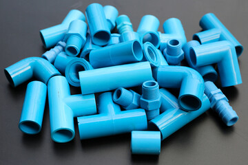 Plumber equipment with blue pvc pipe connections for plumbing work.