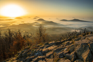 romantic sunrise on the top of the mountains and the remains of the fog in the lowlands