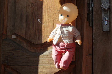 Doll on a wooden door