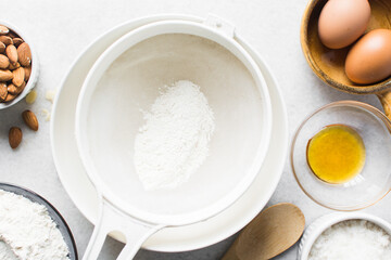 Sifting flour for baking, a plastic sieve with flour in it