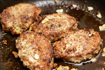 Meat sizzling in a frying pan for a delicious dish