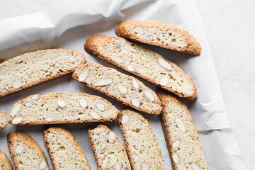 almond biscotti on white marble countertop, almond cantucci cookies on a white board, flatlay of slices of biscotti cookies or twice baked cookies