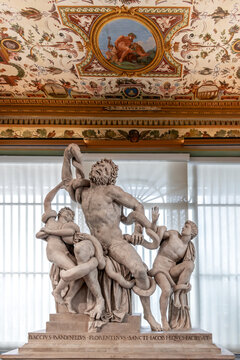 Florence, Italy - 05 April 2024: Laocoon group by Bandinelli 1520 displayed in the Uffizi Gallery in the west corridor under ceiling frescoed with grotesques