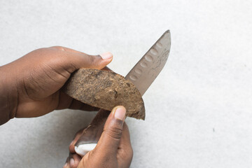Female hands peeling yam, woman peeling nigerian white yam, how to peel African yam