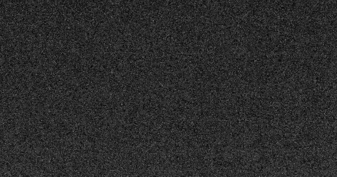 digital noise A close up of a white and gray noise with a grainy texture. The pattern of tints and shades create a contrast with the dark background, giving it a peach and carmine undertone. TV
