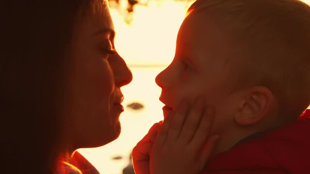 Family walks in the countryside during sunset. Love, parental care and children concept.