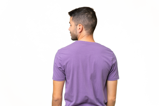 Young handsome caucasian man over isolated background in back position and looking side