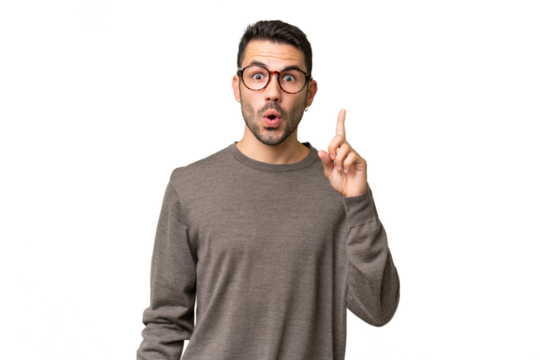 Young handsome caucasian man over isolated background intending to realizes the solution while lifting a finger up