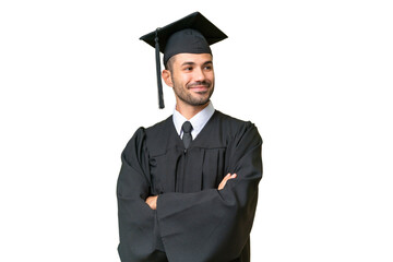 Young university graduate man over isolated background with arms crossed and looking forward