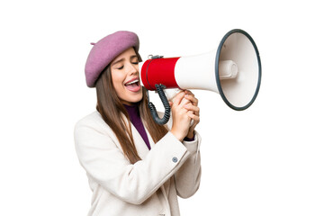 Young beautiful woman over isolated chroma key background shouting through a megaphone