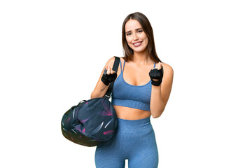 Young sport woman with sport bag over isolated chroma key background making money gesture