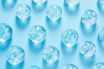 Blue and white glass balls arrangement on blue surface with matching background for decorative concept