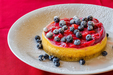 Homemade raspberry pie with a garnish of blueberries