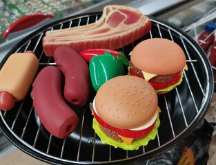 Toy barbecue products on a toy barbecue grill