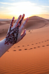 hand with mehendi in the desert