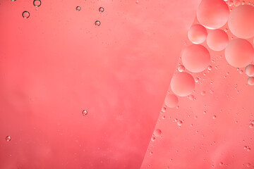 Abstract pink colorful background with oil on water surface. Oil drops in water abstract...