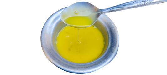 a beaten egg in bowl with spoon.Bowl of egg yolk isolated on white background, top view . png image