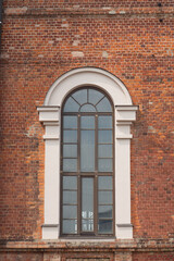 Fototapeta na wymiar Brick facade of a house with a large window