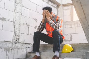 Engineer industry unemployed. Feeling stress, tired and headache asian man sitting depressed on stair at site, worker male crisis in factory, fired unemployment from economy, lost job, jobless concept - obrazy, fototapety, plakaty