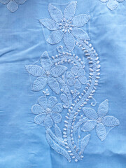 White floral chikankari motif on cotton fabric