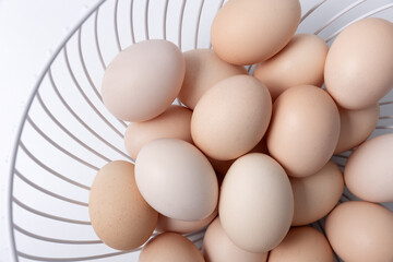 farm fresh eggs in a white wire basket