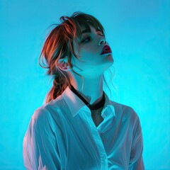 a female wearing smart clothing standing in front of a neon blue background - obrazy, fototapety, plakaty
