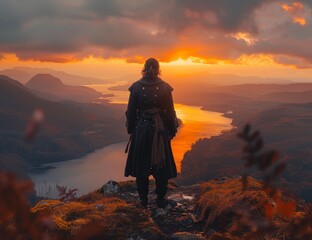 a hiker walks on a rocky mountain in the middle of a misty sunrise.