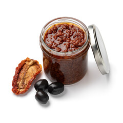 Glass jar with traditional homemade black olive tapenade close up isolated on white background 