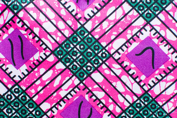 top view of pink ankara fabric, flatlay of nigerian wax cloth with designs, spread out pink ankara...