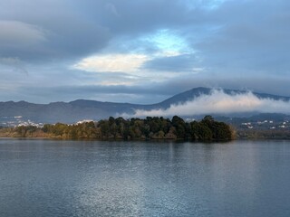 Cloud laying on a mountain near the river Minho near Eiras, O Rosal, Galicia, Spain, March 2023