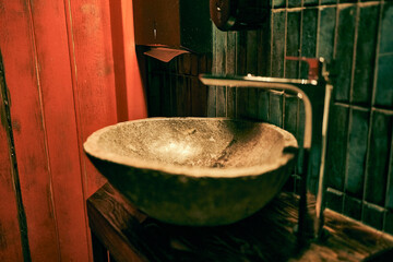 Creepy stone sink in close-up, in a small room. Halloween concept with copy space. High quality photo