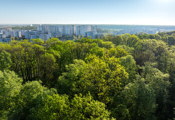 Greenfield Bucharest. Aerial view of this new residential complex with modern apartments next to Baneasa forest in Bucharest, Romania, during a sunny spring morning. Residential construction industry. - obrazy, fototapety, plakaty