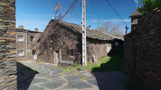 Narrow and picturesque alleys with stone houses on the route of the black villages, Guadalajara.