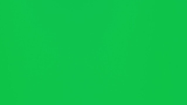 Male hand holding a smartphone with vertical green chroma key screen isolated on green background. Different signs and gestures with fingers. Technology and internet concept. Vertical video.