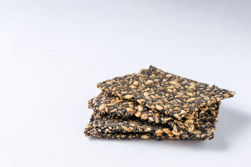 Homemade seed crackers on white background