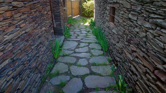 Narrow alley with slate stone houses in the black villages, Guadalajara, Spain.