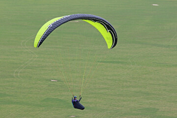 Paraglider flying from a hill	