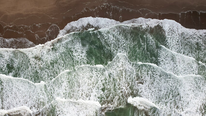 Overhead photo of waves breaking on the beach.