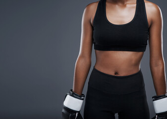 Boxing, fitness and woman with gloves in studio for workout, agility exercise and endurance. Person, sport and boxer with equipment for mma training, strength and resilience on grey background - obrazy, fototapety, plakaty