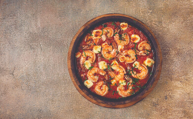 saganaki with shrimp, in a clay pan, Greek dish, shrimp in tomato sauce, feta cheese, homemade, no people,